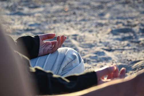 a close up of a person laying in the sand