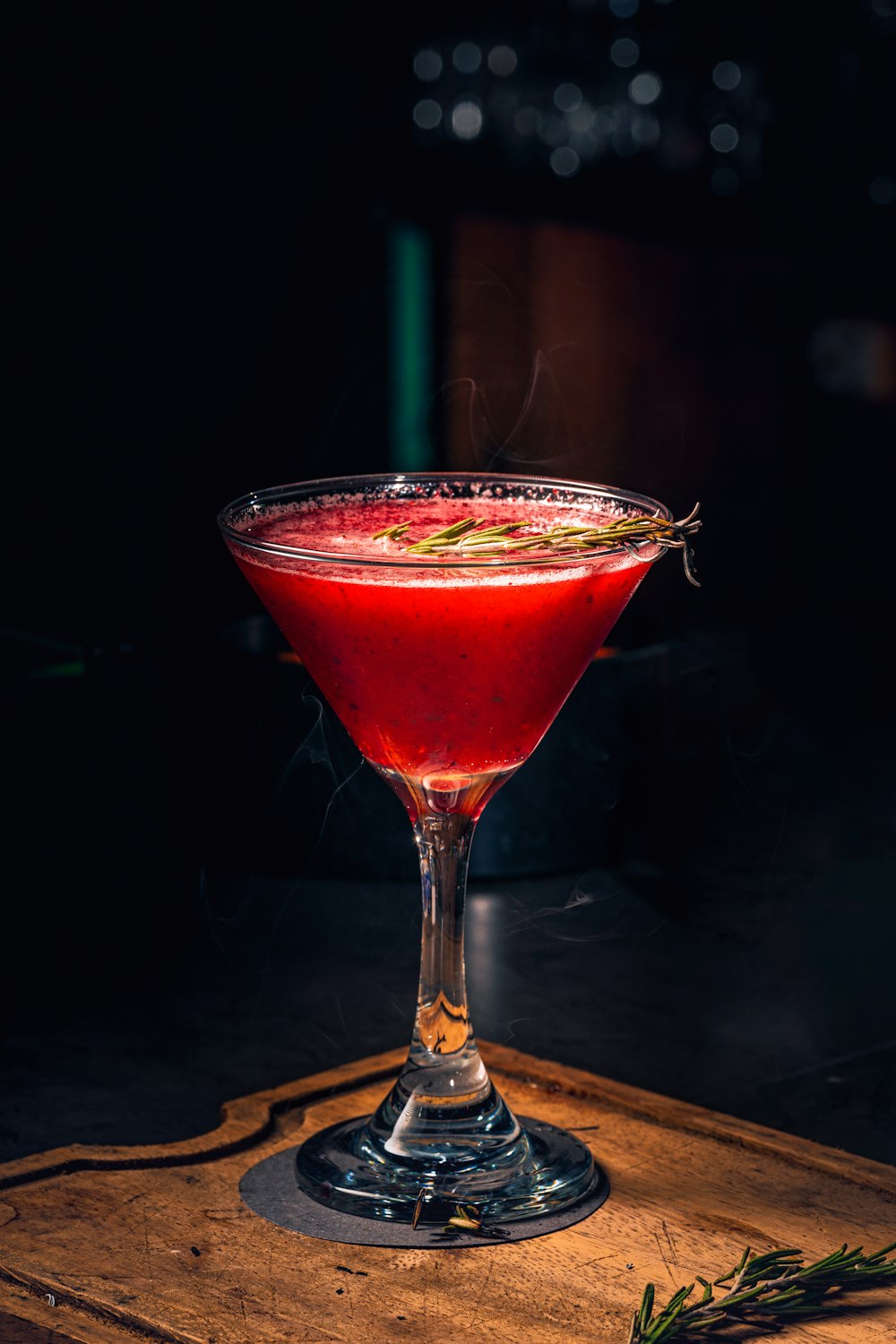 a red drink sitting on top of a wooden table