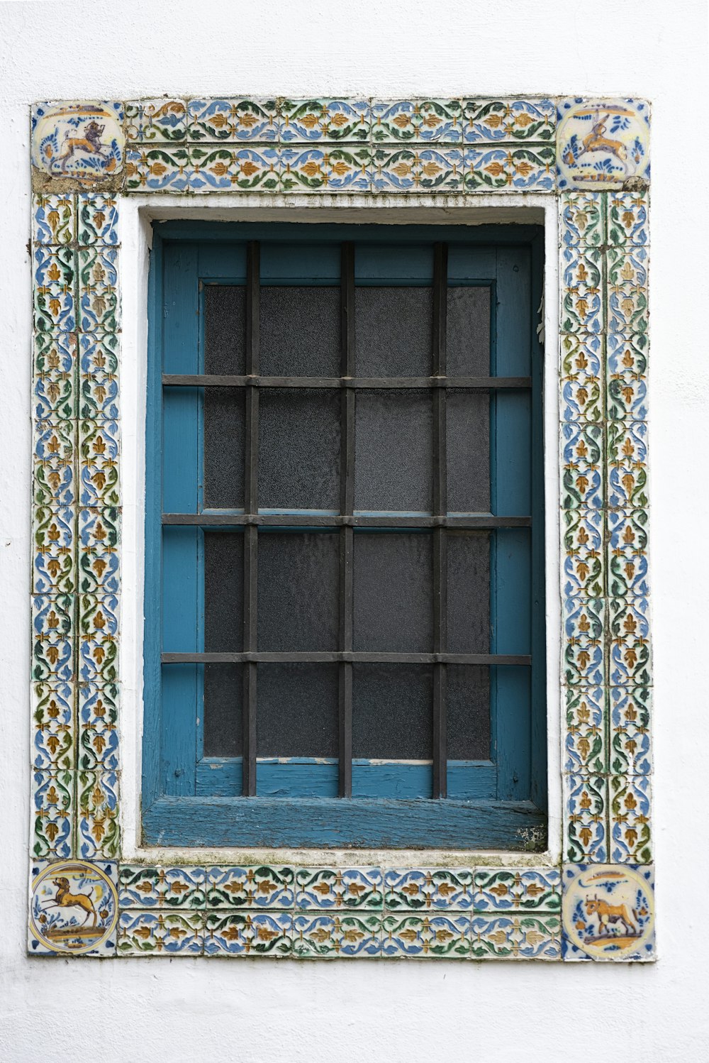 a window with a blue and green frame