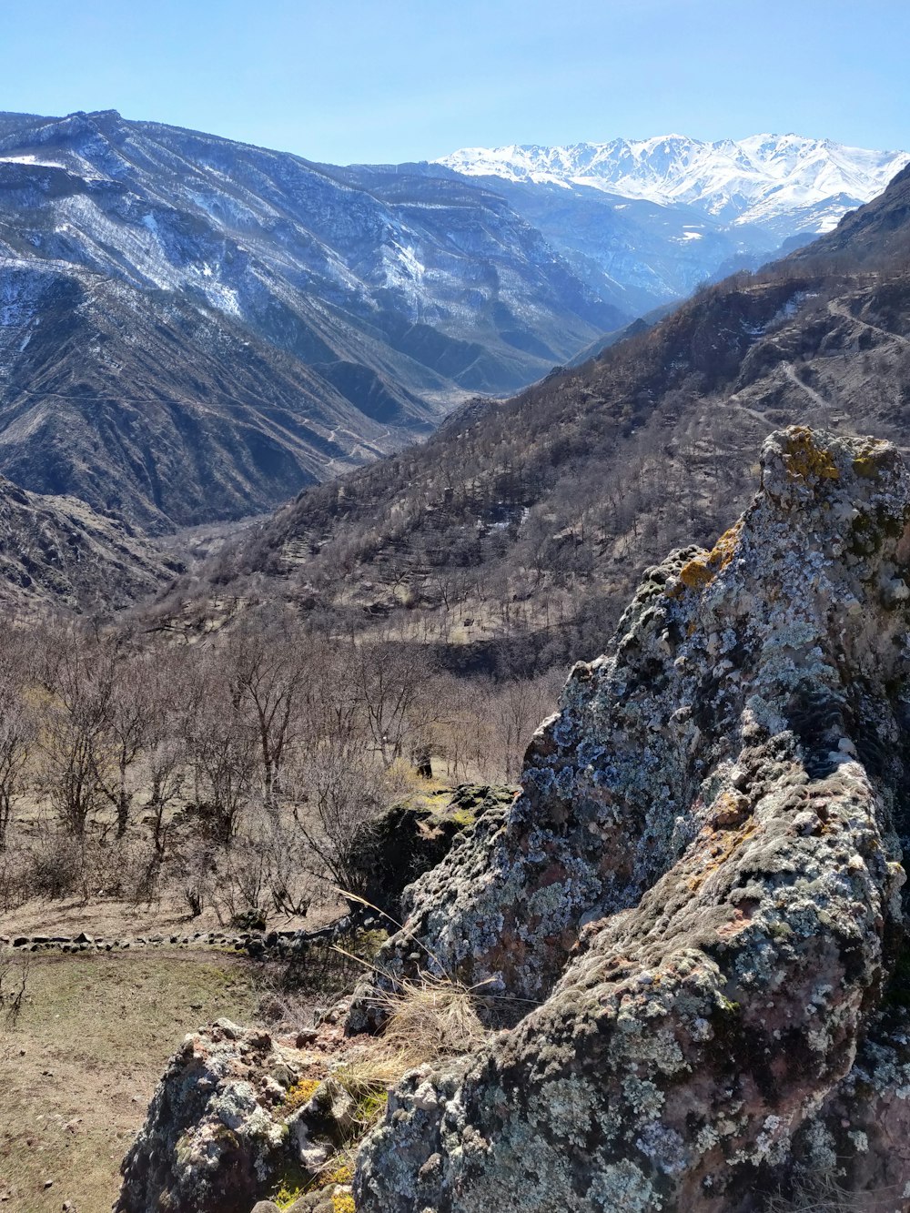 a view of a mountain range with snow capped mountains in the distance