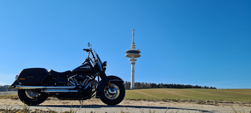 a black motorcycle parked on a dirt road