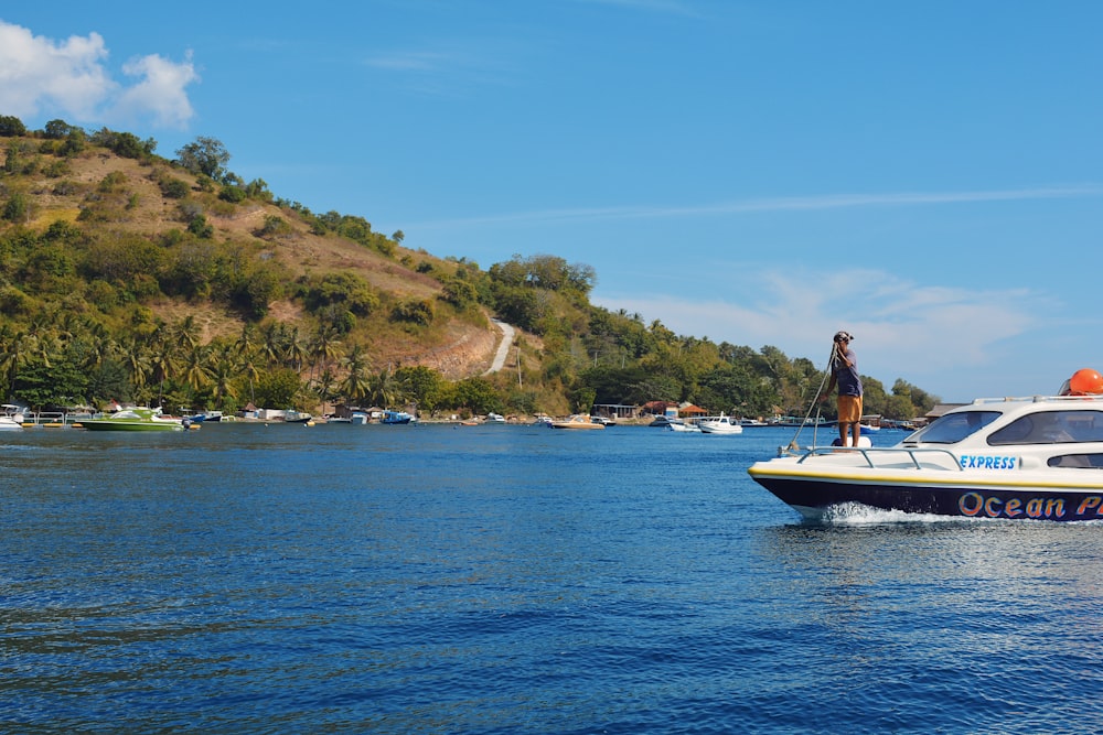 a man is standing on a boat in the water