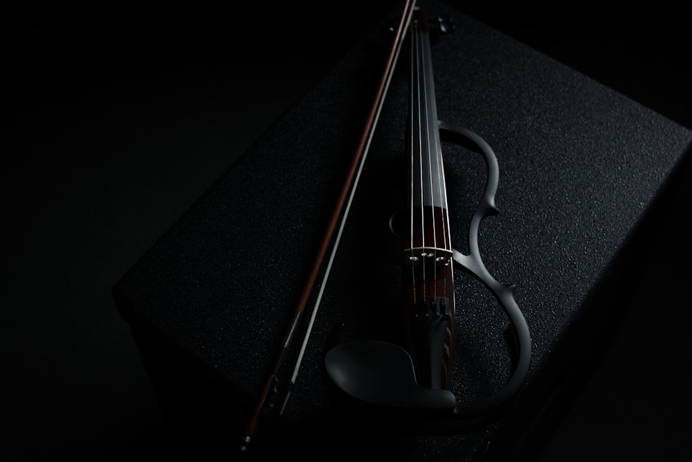 a violin sitting on top of a black box