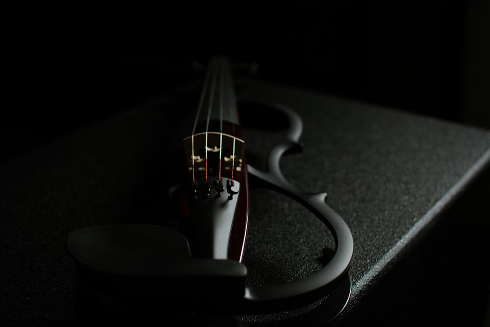 a close up of a violin in the dark
