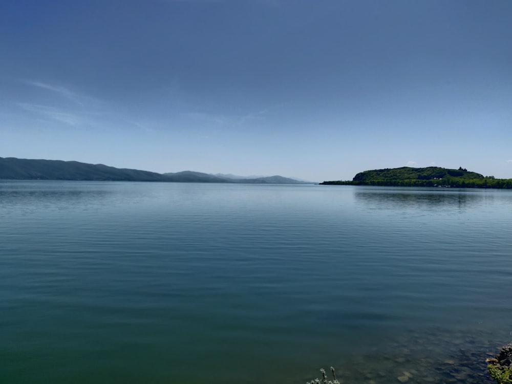 a body of water with a small island in the distance