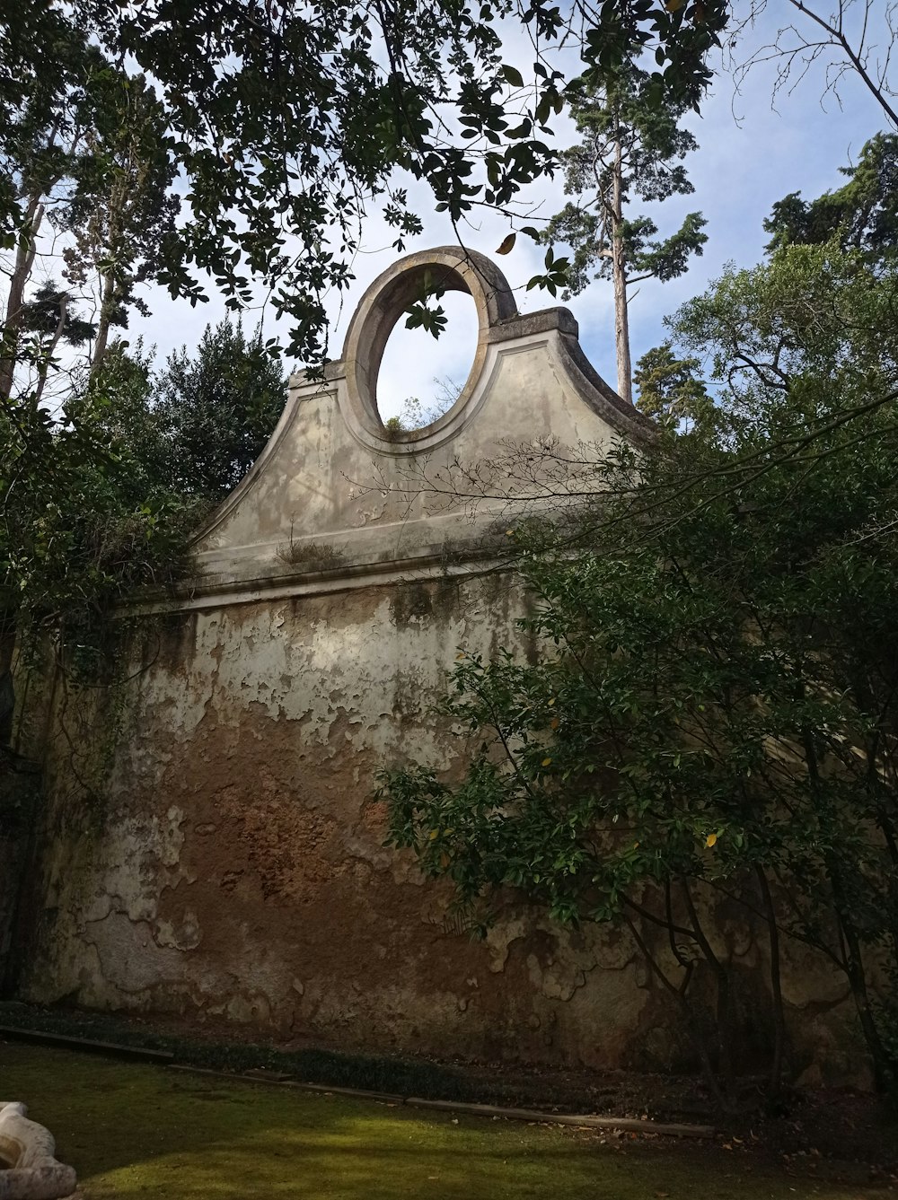 an old building with a circular window in the middle of it