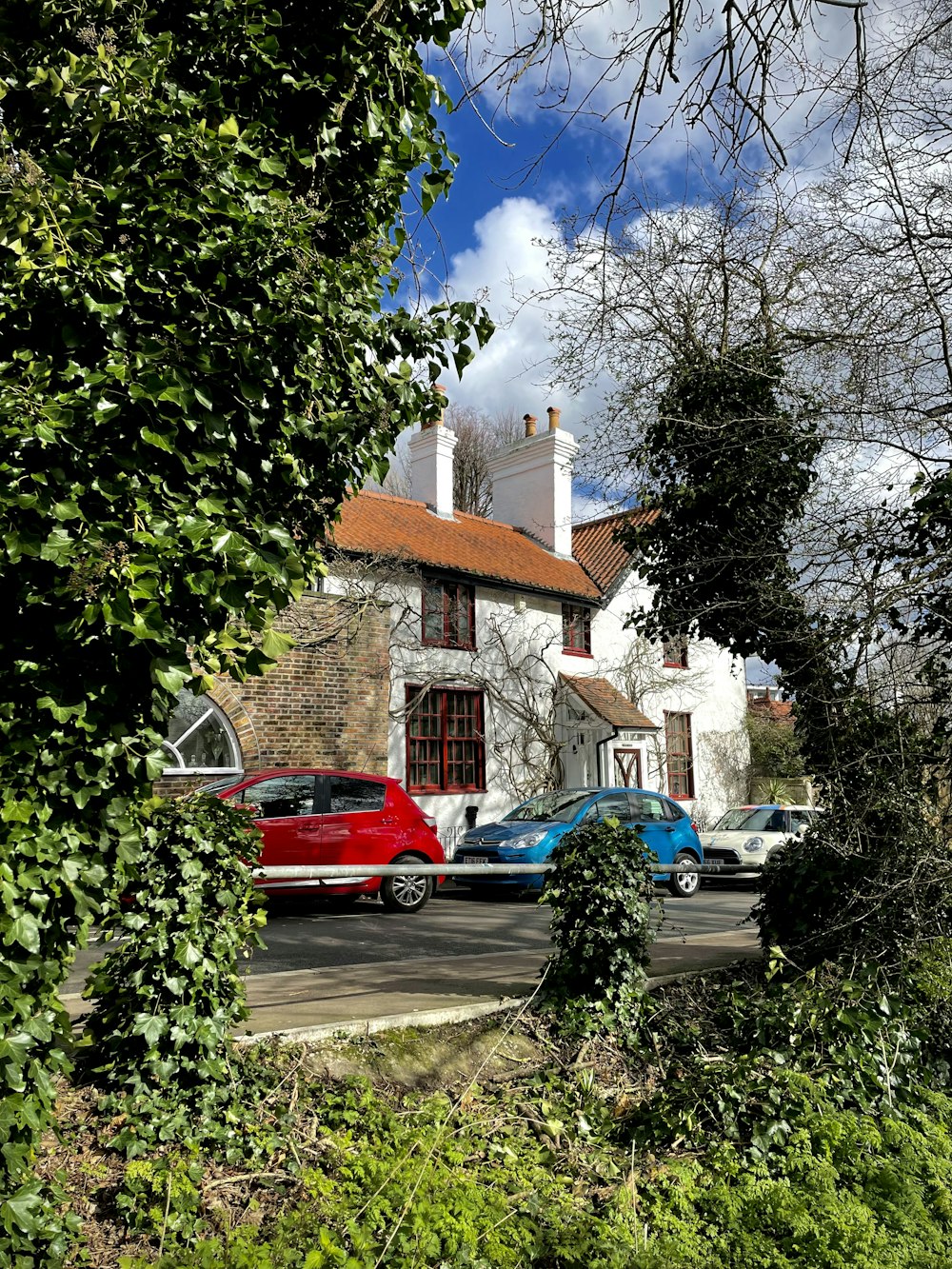 a red truck is parked in front of a house