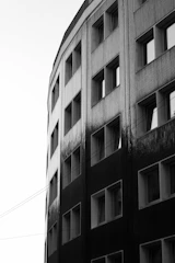 Black and white photo of a modern building facade with soft shadows and gradient lighting