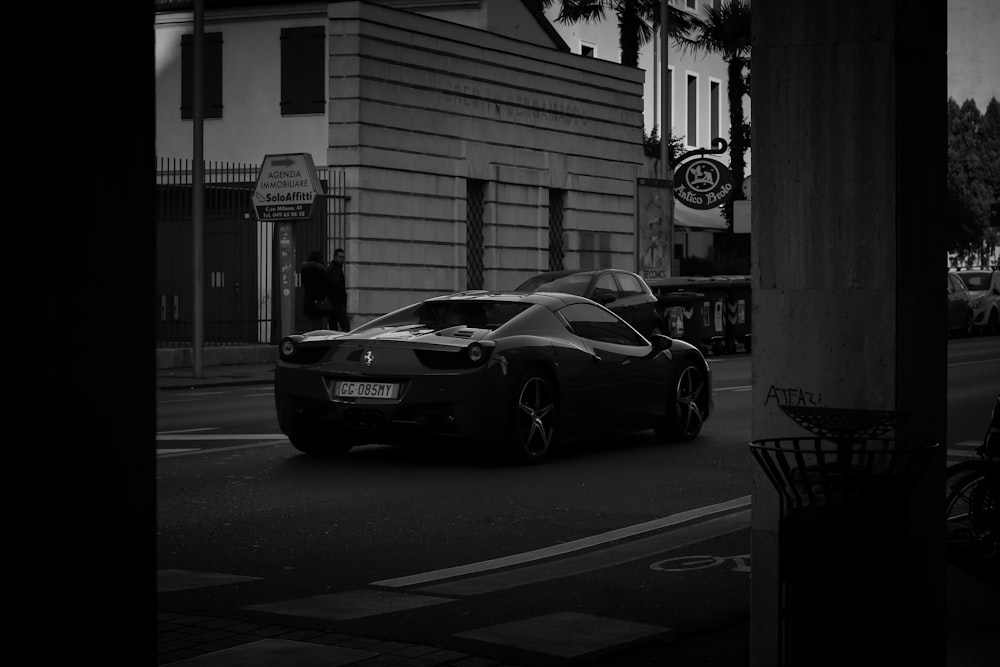 a black and white photo of a sports car