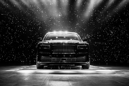 a black and white photo of a car on a stage