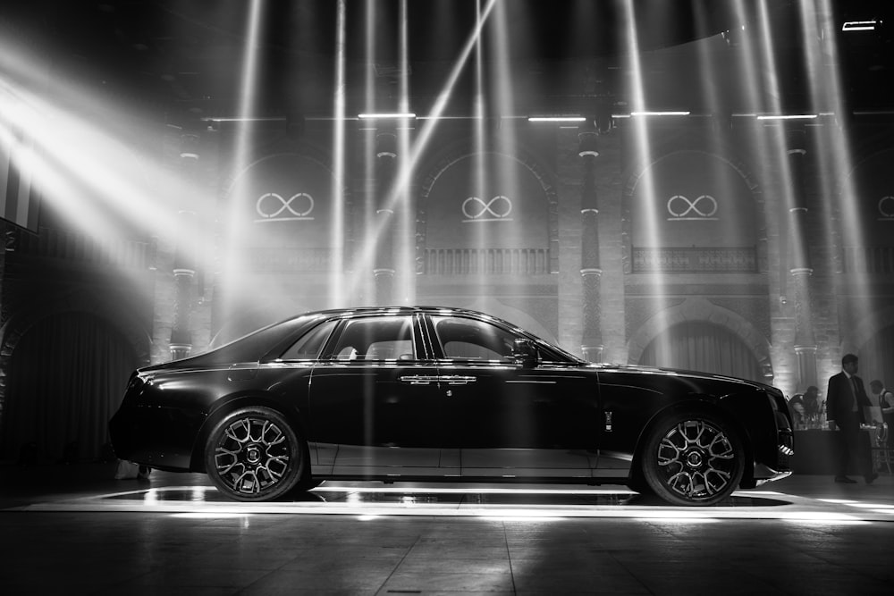 a black car parked in front of a stage