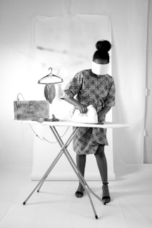 a woman ironing clothes on an ironing board