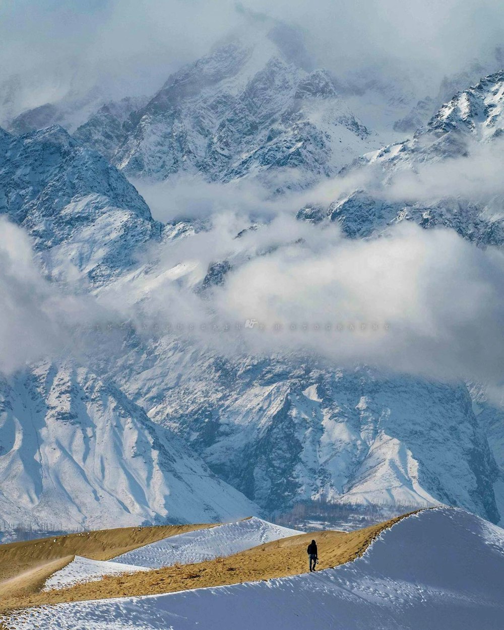 a person walking up a snow covered mountain