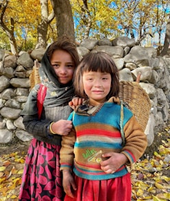 two young girls standing next to each other
