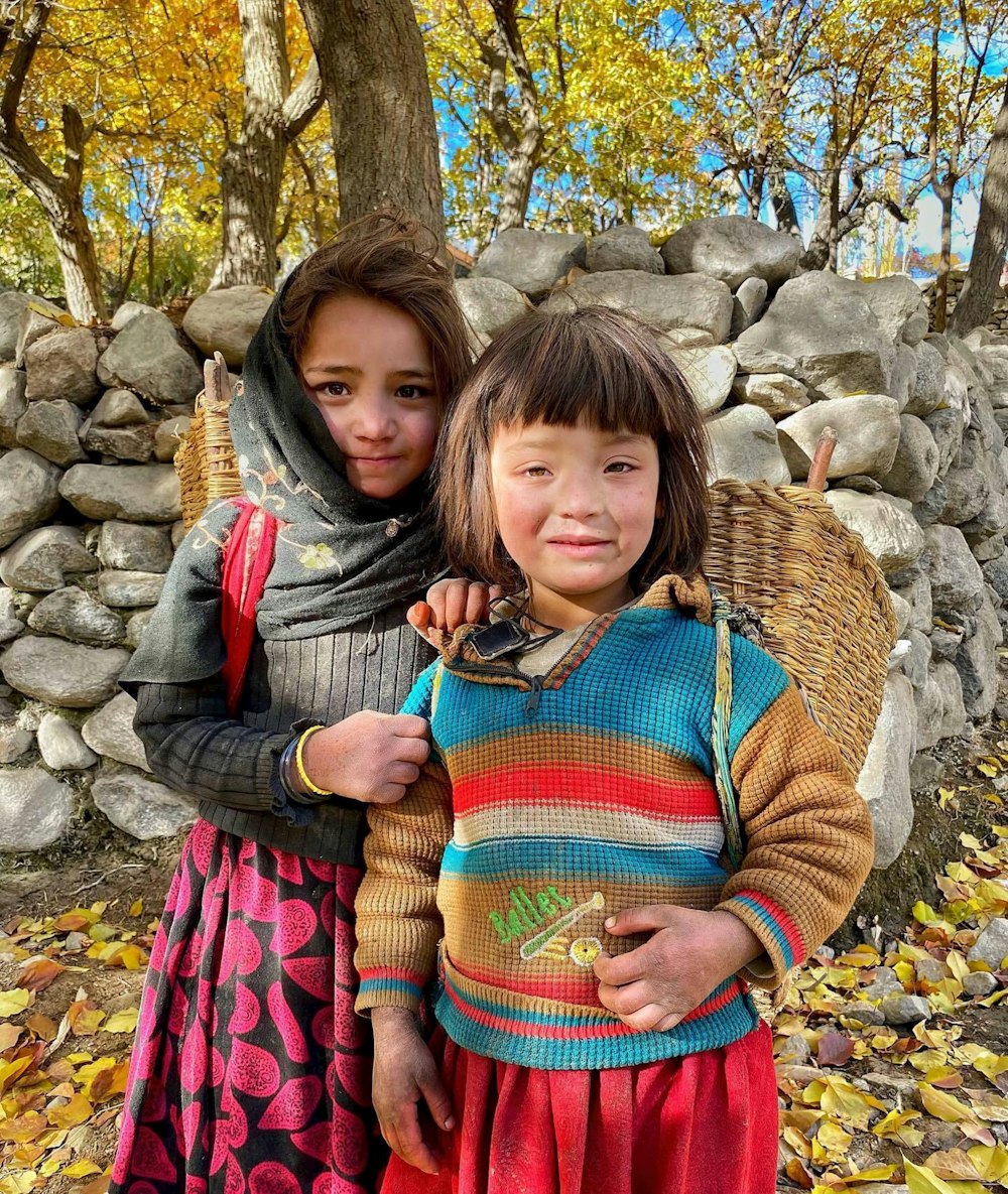 two young girls standing next to each other