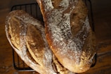a couple of loaves of bread sitting on top of a rack
