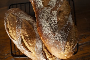 a couple of loaves of bread sitting on top of a rack