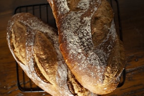 a couple of loaves of bread sitting on top of a rack