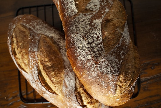 a couple of loaves of bread sitting on top of a rack