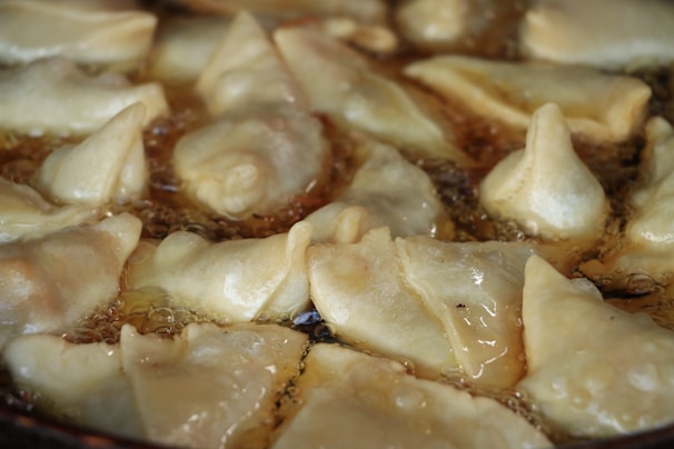 A close-up of a frying machine with food being cooked.