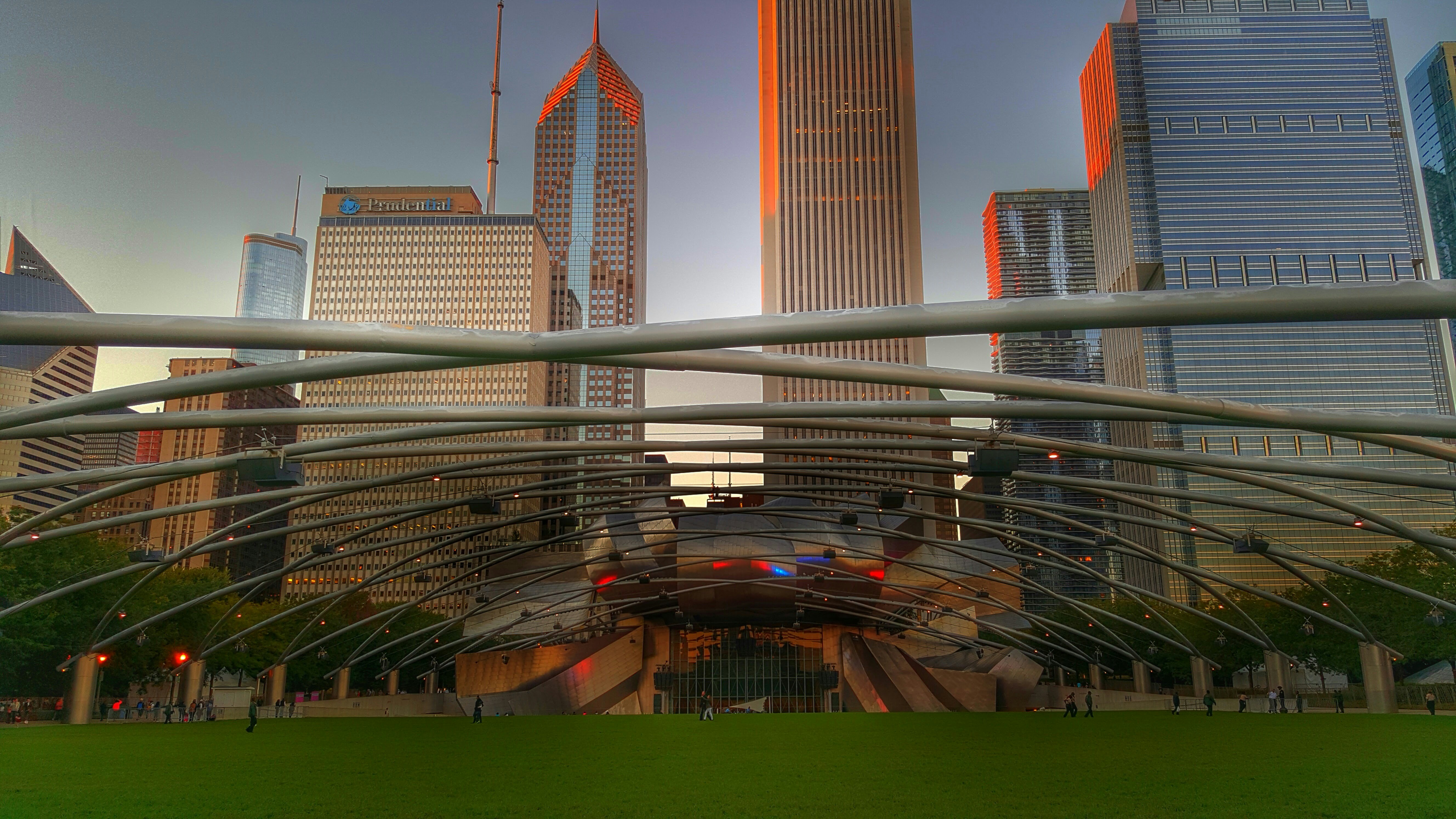 A city with tall buildings and a green field