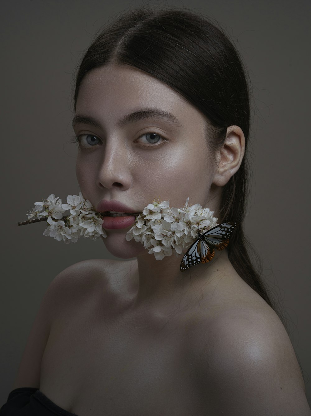 a woman with a butterfly on her nose