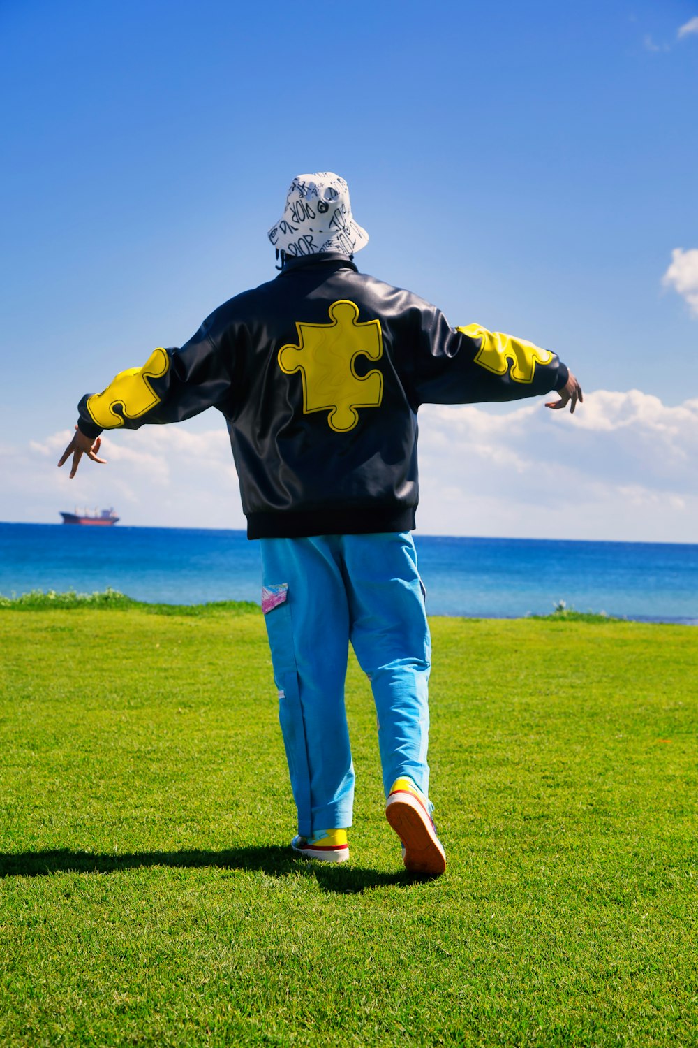 a person walking across a lush green field