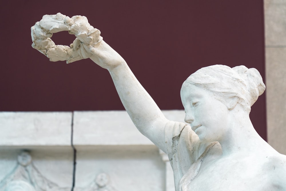 a statue of a woman holding a piece of bread