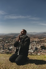 A group of people praying on a mountain top.
