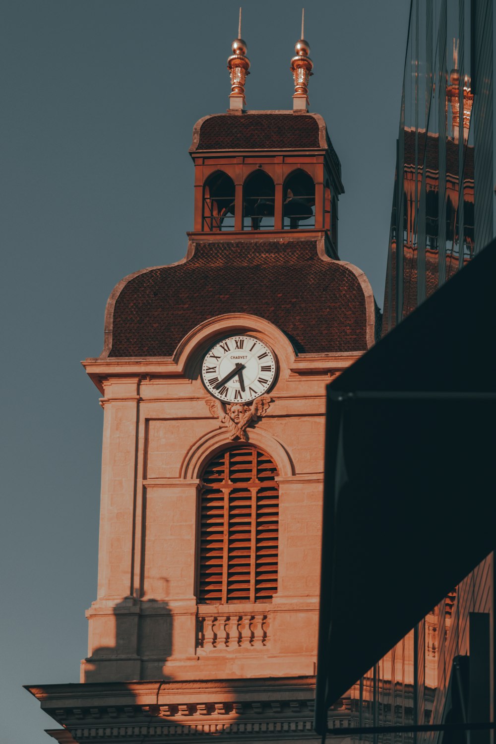 a tall clock tower with a clock on each of it's sides