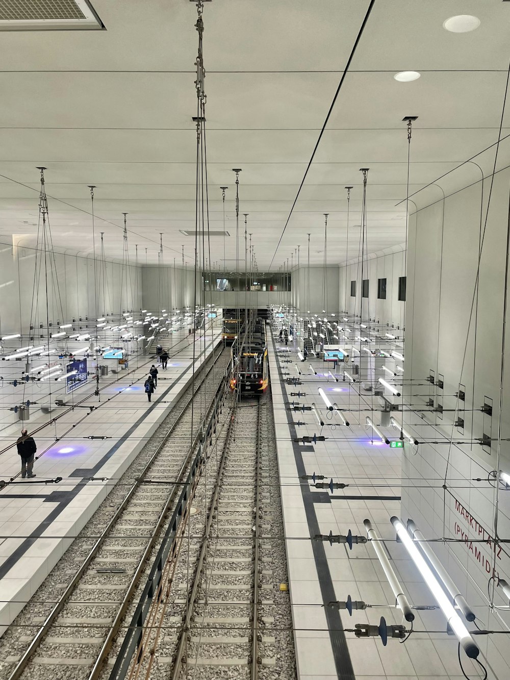 a train traveling through a train station next to tall buildings