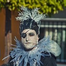 a man in a costume with feathers and feathers on his head