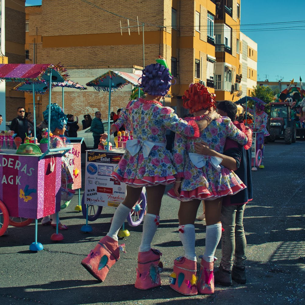 a couple of girls that are standing in the street