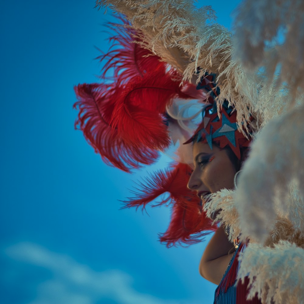 a woman wearing a red and white feather headdress