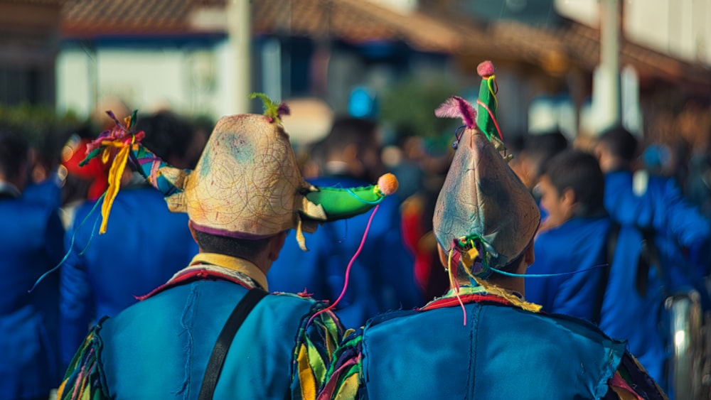 a group of people in blue jackets and hats