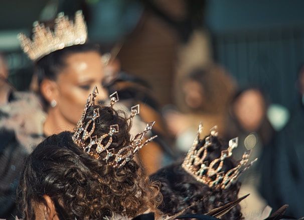 a group of women wearing crowns standing next to each other