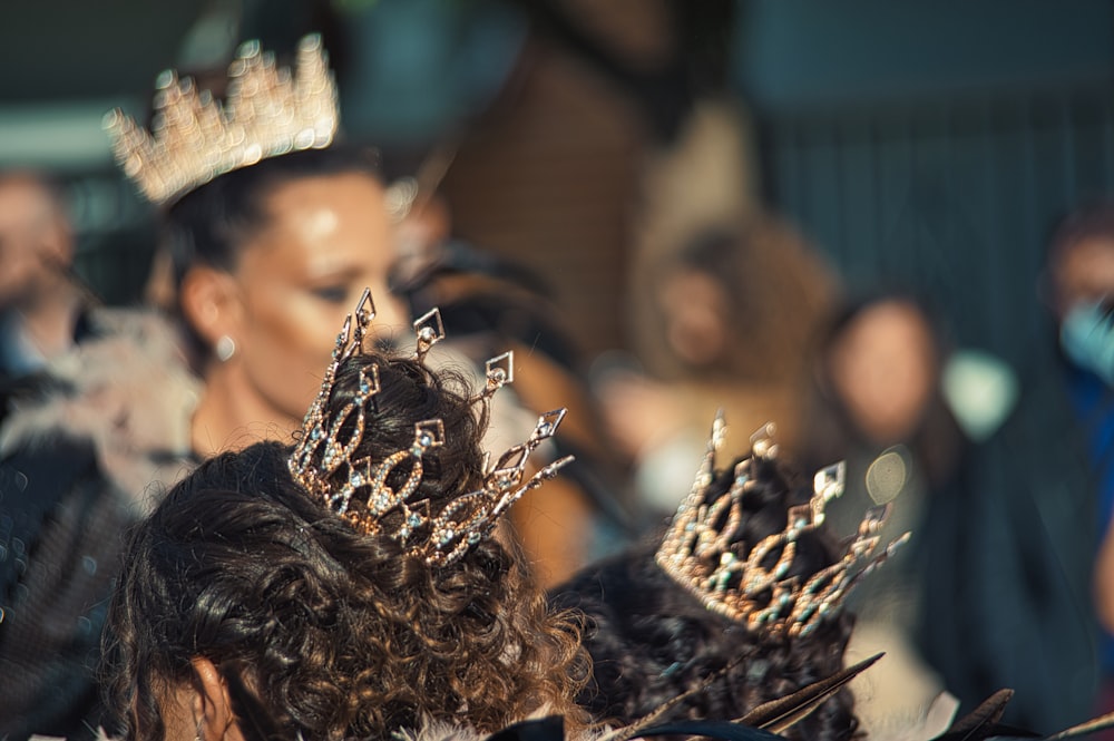 a group of women wearing crowns standing next to each other