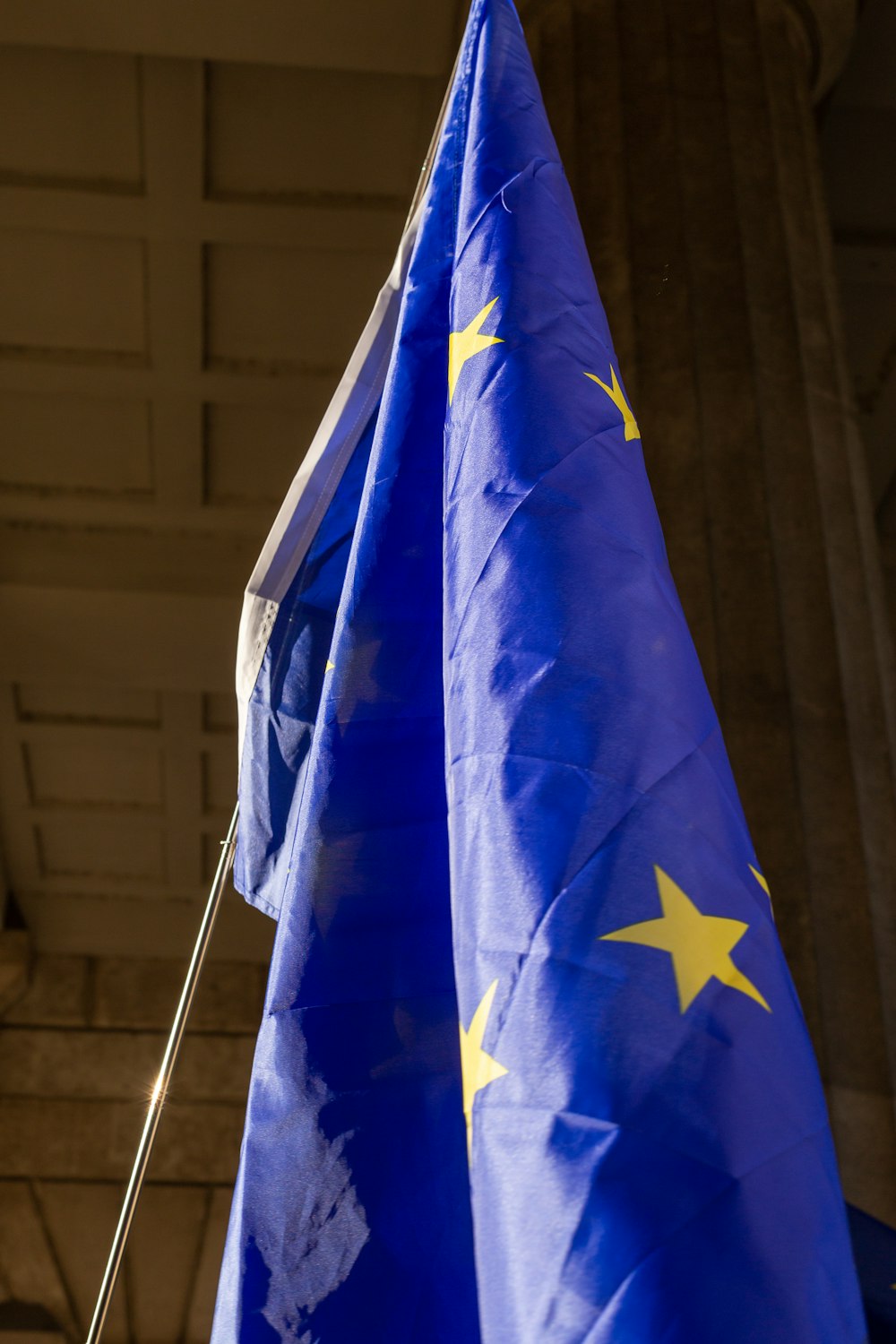 a blue and yellow flag hanging from a ceiling