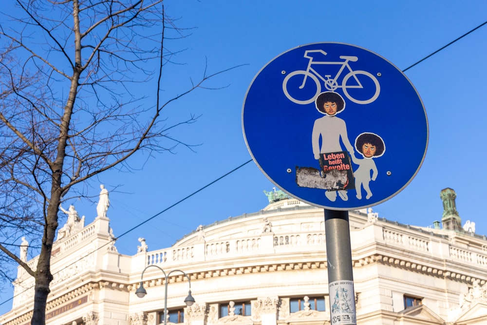 a blue street sign with a picture of a woman and a child on it