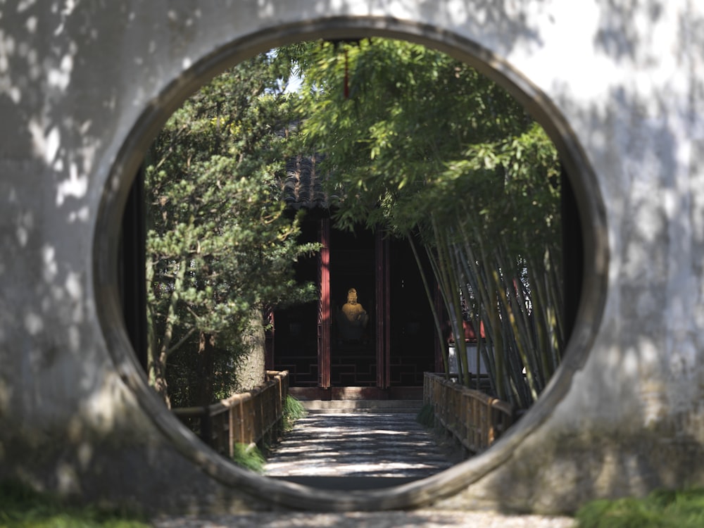 a view of a walkway through a circular mirror