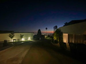A serene evening view of a modern Nairobi villa illuminated softly under moody lighting.