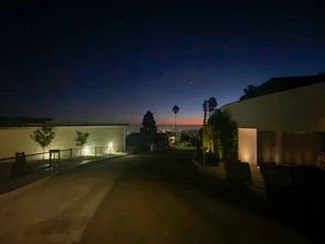 A twilight view of Balcarce Estates’ property lights glowing softly against the evening sky.