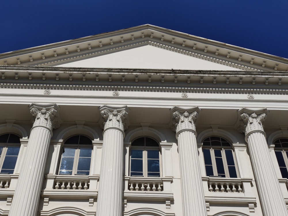 a tall white building with columns and windows