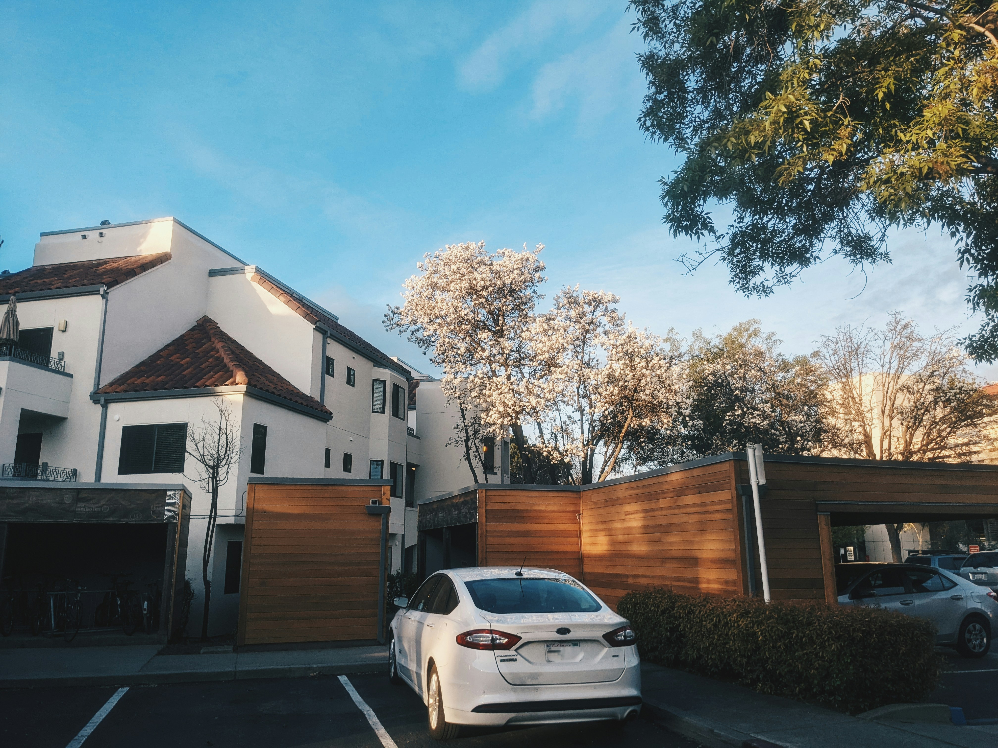 a white car parked in front of a house