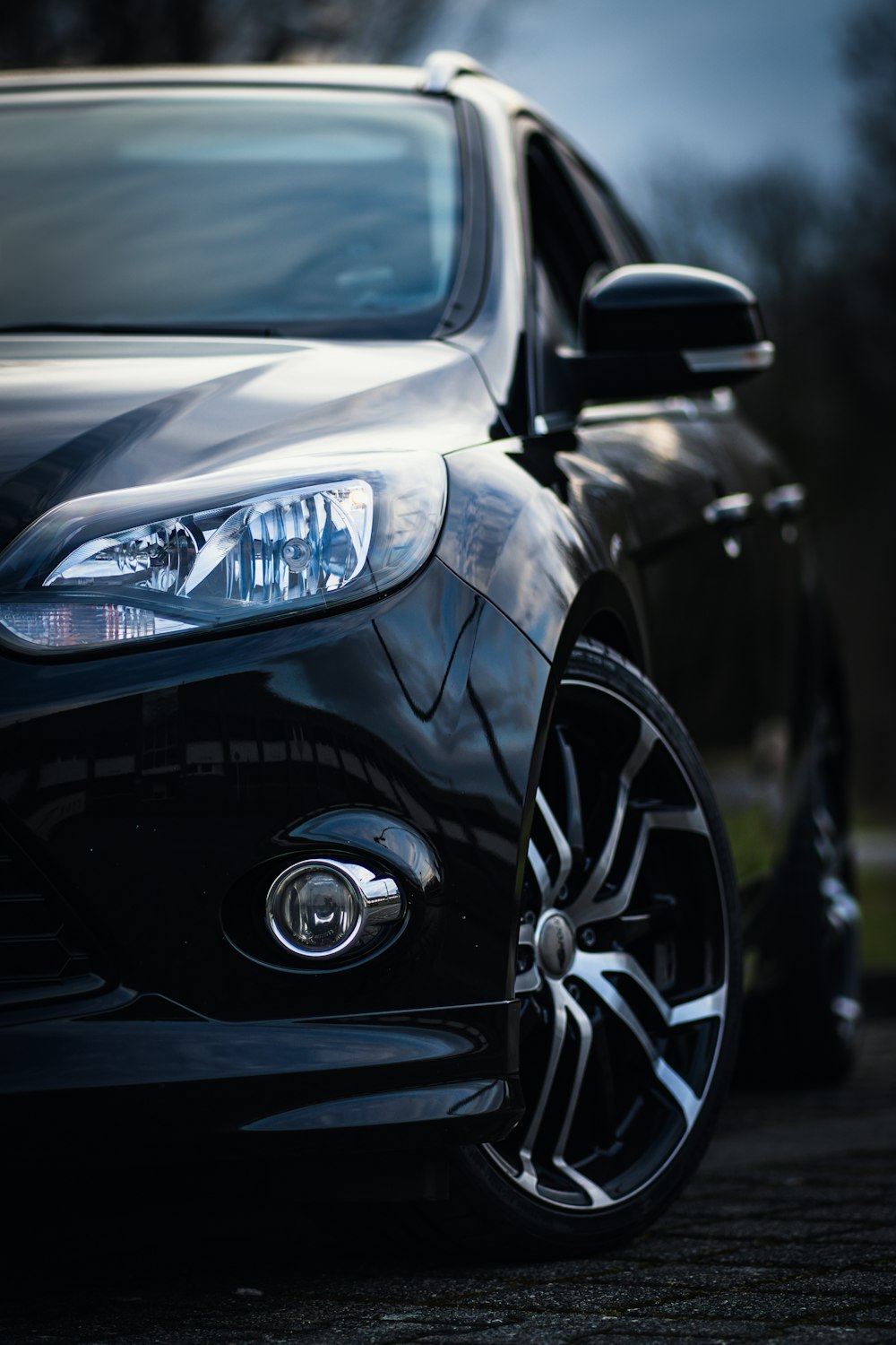 a close up of a car parked on a street