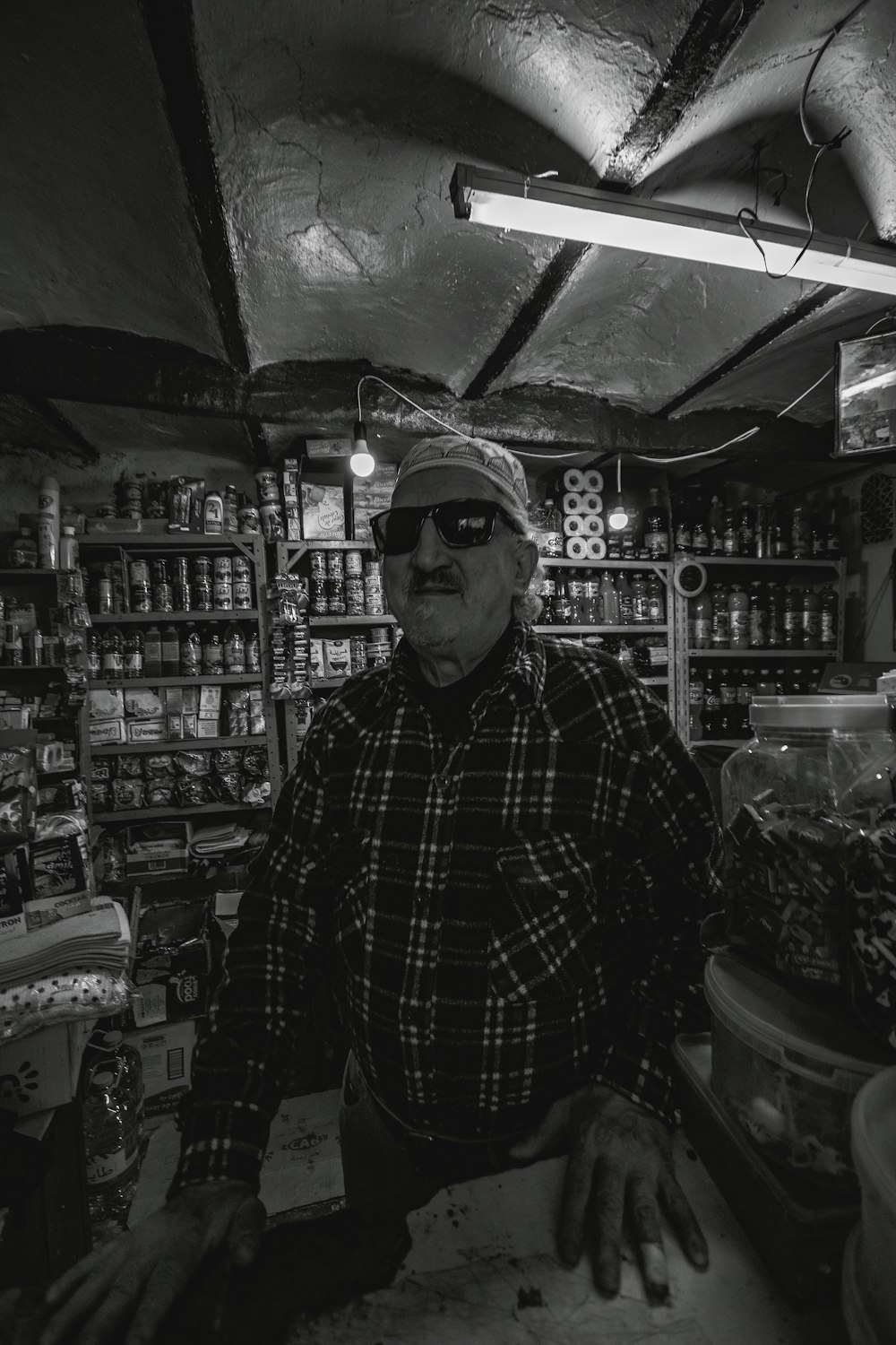 a man standing in front of a store filled with items