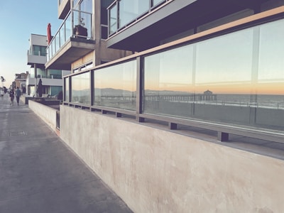 people walking on a sidewalk next to a building