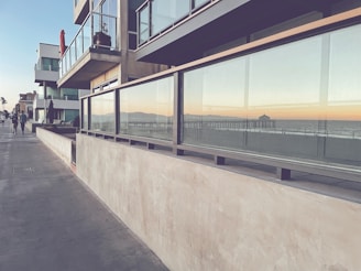 people walking on a sidewalk next to a building