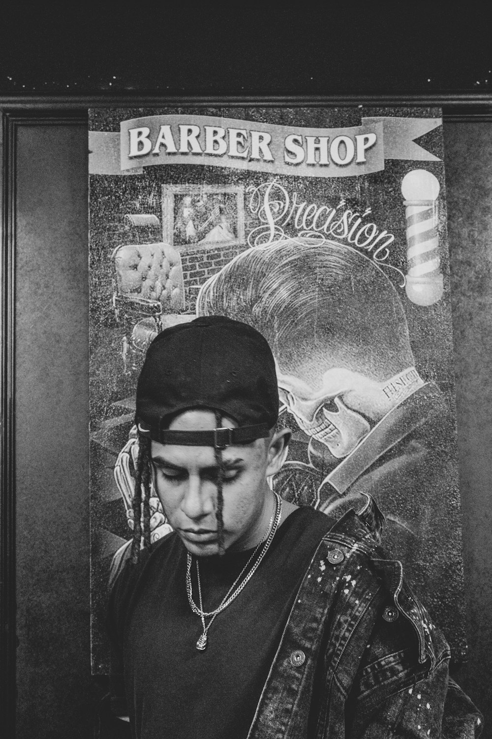 Una foto in bianco e nero di un uomo in un negozio di barbiere
