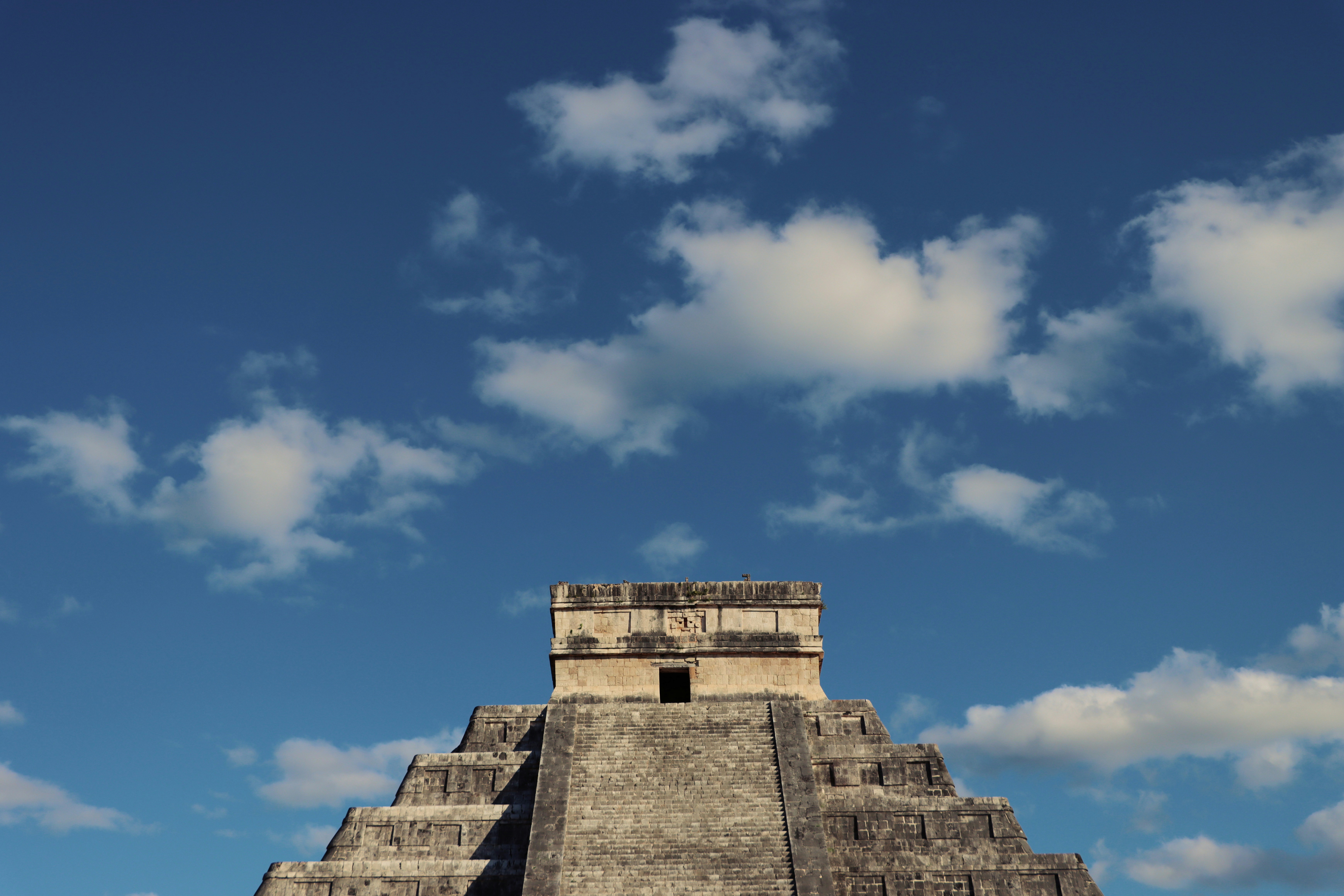 a very tall pyramid with a sky background, 